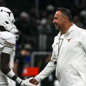 Texas Longhorns head coach Steve Sarkisian greets wide receiver Xavier Worthy (1) while warming up for the Sugar Bowl College Football Playoff  semifinals game against the Washington Huskies at the Caesars Superdome on Monday, Jan. 1, 2024 in New Orleans, Louisiana.