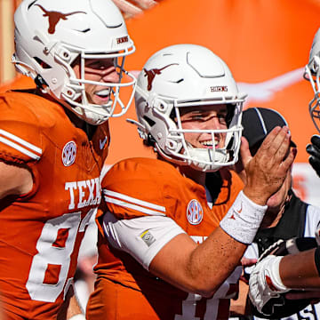 Texas Longhorns offensive lineman Trevor Goosby (74) and quarterback Arch Manning (16) celebrate a rushing toughdown by Manning during the game against Colorado State at Darrell K Royal-Texas Memorial Stadium in Austin Saturday, Aug. 31, 2024.