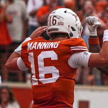 Texas Longhorns quarterback Arch Manning (16) and running back Quintrevion Wisner (26) celebrate a touchdown by Manning during the game against UTSA at Darrell K Royal-Texas Memorial Stadium in Austin Saturday, Sept. 14, 2024.