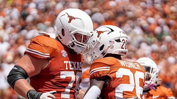 Texas Longhorns offensive lineman Hayden Conner (76) and running back Quintrevion Wisner (26) celebrate a touchdown against C