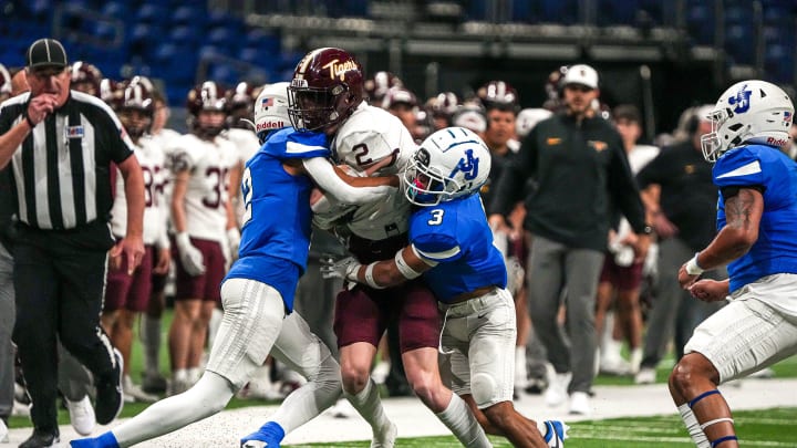 Dripping Springs wide receiver Cooper Reid (2) is tackled during the game against John Jay High School at the Alamodome on Saturday, Nov. 25, 2023 in San Antonio, Texas.