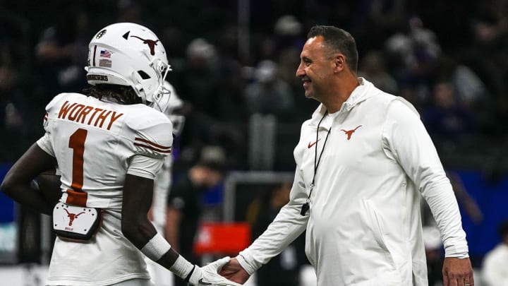 Texas Longhorns head coach Steve Sarkisian greets wide receiver Xavier Worthy (1) while warming up for the Sugar Bowl College Football Playoff  semifinals game against the Washington Huskies at the Caesars Superdome on Monday, Jan. 1, 2024 in New Orleans, Louisiana.
