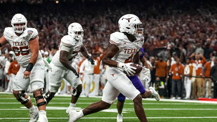 Texas Longhorns running back CJ Baxter (4) runs in for a touchdown during the Sugar Bowl College Football Playoff  semifinals game against the Washington Huskies at the Caesars Superdome on Monday, Jan. 1, 2024 in New Orleans, Louisiana.