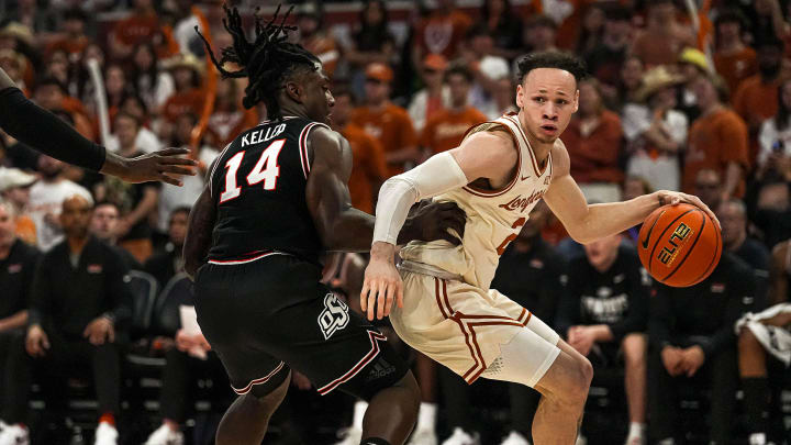 Texas Longhorns guard Chendall Weaver (2) is guarded by Oklahoma State guard Jamyron Keller (14) during the basketball at the Moody Center on Saturday, Mar. 2, 2024 in Austin.