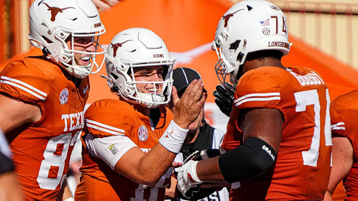 Texas Longhorns offensive lineman Trevor Goosby (74) and quarterback Arch Manning (16) celebrate a rushing toughdown by Manning during the game against Colorado State at Darrell K Royal-Texas Memorial Stadium in Austin Saturday, Aug. 31, 2024.