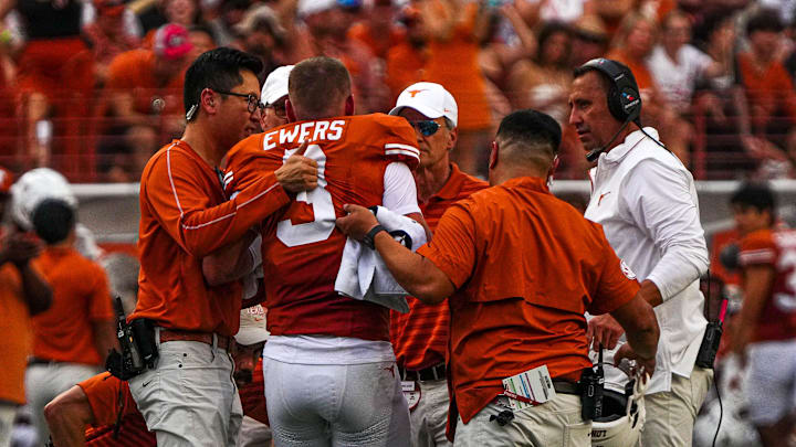 Texas Longhorns quarterback Quinn Ewers (3) is helped off the field after an injury during the game against UTSA at Darrell K Royal-Texas Memorial Stadium in Austin Saturday, Sept. 14, 2024.