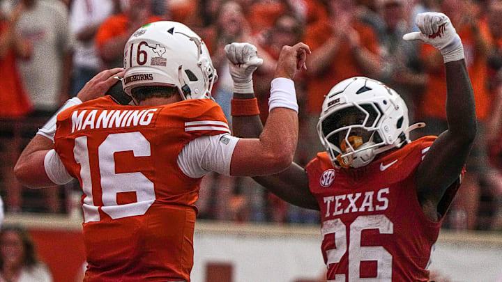 Texas Longhorns quarterback Arch Manning (16) and running back Quintrevion Wisner (26) celebrate a touchdown by Manning during the game against UTSA at Darrell K Royal-Texas Memorial Stadium in Austin Saturday, Sept. 14, 2024.