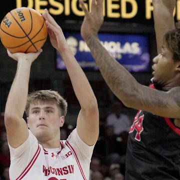 Wisconsin forward Nolan Winter (31) hits a three-point basket s Ball State forward Mason Jones (24) defends during the second half of their game Tuesday, November 11, 2025 at the Kohl Center in Madison, Wisconsin. Wisconsin beat Ball State 86-55.