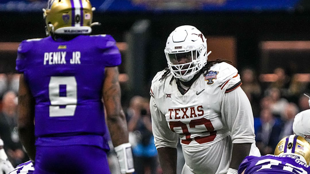 Texas Longhorns defensive lineman T'Vondre Sweat (93) watches Washington quarterback Michael Penix