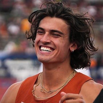 Jun 9, 2023; Austin, TX, USA; Texas athlete Sam Hurley runs to hug a coach before competing in high jump finals at the 2023 NCAA outdoor track and field championships at Mike A. Myers Stadium. Mandatory Credit: Aaron E. Martinez-Imagn Images