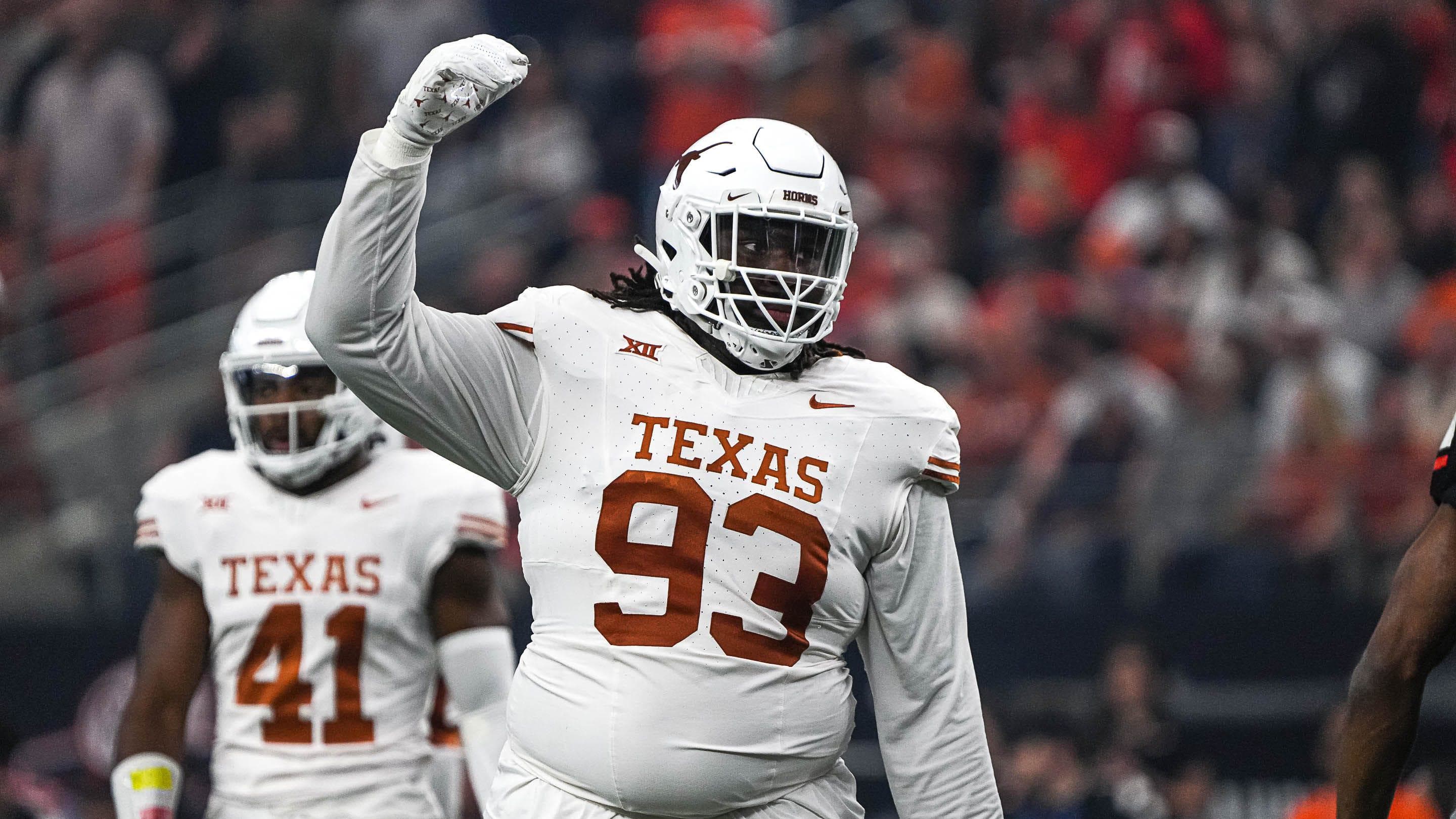 Texas Longhorns defensive lineman T'Vondre Sweat celebrates a play during a college football game.