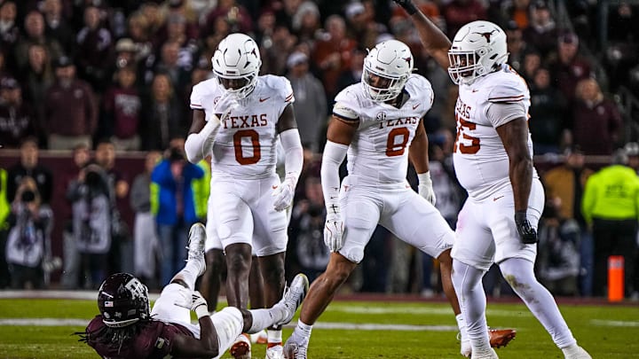 Nov 30, 2024; College Station, Texas, USA; Texas Longhorns linebacker Anthony Hill Jr. (0) looks down at Texas A&M running back Amari Daniels (5) after a tackle during the Lone Star Showdown at Kyle Field. Mandatory Credit: Sara Diggins/USA TODAY Network via Imagn Images Nov 30, 2024; College Station, Texas, USA; Texas Longhorns linebacker Anthony Hill Jr. (0) looks down at Texas A&M running back Amari Daniels (5) after a tackle during the Lone Star Showdown at Kyle Field. Mandatory Credit: Sara Diggins/USA TODAY Network via Imagn Images