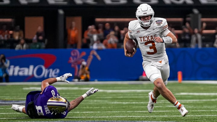 Texas Longhorns quarterback Quinn Ewers (3) evades a tackle by Washington edge Bralen Trice (8) during the Sugar Bowl College Football Playoff  semifinals game at the Caesars Superdome on Monday, Jan. 1, 2024 in New Orleans, Louisiana.