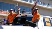 Oct 20, 2024; Austin, Texas, USA; McLaren Racing drivers Lando Norris and Oscar Piastri wave to the crowd during the drivers' parade at the Formula 1 Pirelli United States Grand Prix at Circuit of the Americas. Mandatory Credit: Aaron E. Martinez-Imagn Images