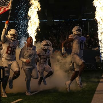 Texas Longhorns head coach Steve Sarkisian leads his team onto the field for the Sugar Bowl College Football Playoff  semifinals game against the Washington Huskies at the Caesars Superdome on Monday, Jan. 1, 2024 in New Orleans, Louisiana.