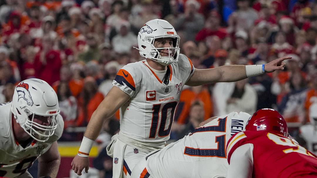 Dec 25, 2025; Kansas City, Missouri, USA; Denver Broncos quarterback Bo Nix (10) gestures on the line of scrimmage during the first quarter at GEHA Field at Arrowhead Stadium. 