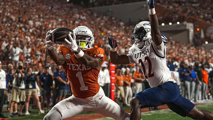 Sep 14, 2024; Austin, Texas, USA; Texas Longhorns receiver Johntay Cook II (1) makes a touchdown catch over UTSA safety Elijah Newell (22) during the game at Darrell K Royal–Texas Memorial Stadium. Mandatory Credit: Aaron E. Martinez/USA TODAY Network via Imagn Images