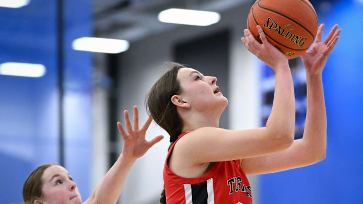 Wauwatosa East center Evelyn Antczak (32) moves to the basket past Germantown guard Avery O'Brien (44) in a Greater Metro Conference game Friday, December 5, 2025. Wauwatosa East center Evelyn Antczak (32) moves to the basket past Germantown guard Avery O'Brien (44) in a Greater Metro Conference game Friday, December 5, 2025.