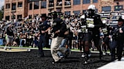 Colorado Buffaloes head coach Deion Sanders leads the team onto the field before the game against the Delaware Blue Hens
