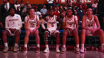From left, Texas Longhorns starters Madison Booker (35), Shay Holle (10), Rori Harmon (3), Jordan Lee (7), and Taylor Jones (44) sit on the bench ahead of player introductions.