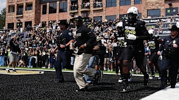 Colorado Buffaloes head coach Deion Sanders leads the team onto the field before the game against the Delaware Blue Hens