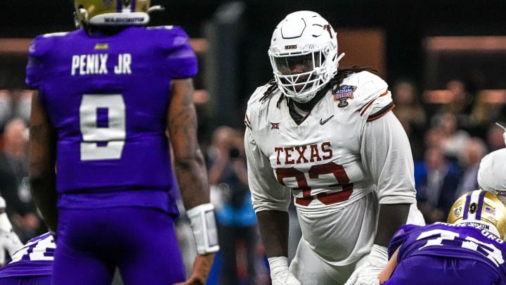 Texas Longhorns defensive lineman T'Vondre Sweat (93) watches Washington quarterback Michael Penix Jr. (9) before a snap during the Sugar Bowl College Football PlayoffÂ semifinals game at the Caesars Superdome on Monday, Jan. 1, 2024 in New Orleans, Louisiana.