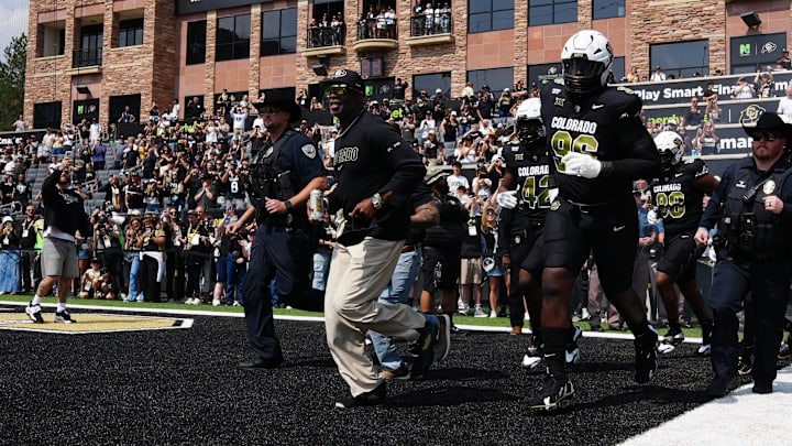 Colorado Buffaloes head coach Deion Sanders leads the team onto the field before the game against the Delaware Blue Hens
