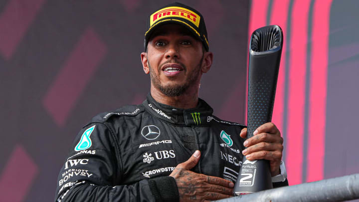 Mercedes AMG Petronas driver Lewis Hamilton holds the second place trophy after a podium finish in