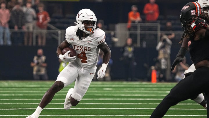 Texas Longhorns running back CJ Baxter (4) runs the ball during the Big 12 Championship game against the Oklahoma State Cowboys at AT&T stadium on Saturday, Dec. 2, 2023 in Arlington.