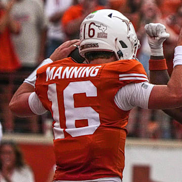 Texas Longhorns quarterback Arch Manning (16) and running back Quintrevion Wisner (26) celebrate a touchdown by Manning during the game against UTSA at Darrell K Royal-Texas Memorial Stadium in Austin Saturday, Sept. 14, 2024.