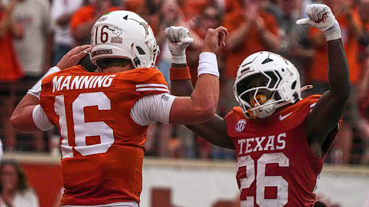 Texas Longhorns quarterback Arch Manning (16) and running back Quintrevion Wisner (26) celebrate a touchdown by Manning during the game against UTSA at Darrell K Royal-Texas Memorial Stadium in Austin Saturday, Sept. 14, 2024.