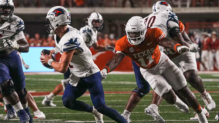 Sep 14, 2024; Austin, Texas, USA; Texas Longhorns edge Colin Simmons (11) pressures UTSA quarterback Owen McCown (2) during the game at Darrell K Royal–Texas Memorial Stadium. Mandatory Credit: Aaron E. Martinez/USA TODAY Network via Imagn Images