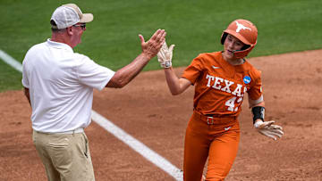 Texas Longhorns infielder Leighann Goode (43) high fives head coach Mike White at third after a home run during the NCAA D1 Softball Tournament Regional against UCF at Red and Charline McCombs Field on Sunday, May 18, 2025 in Austin, Texas.