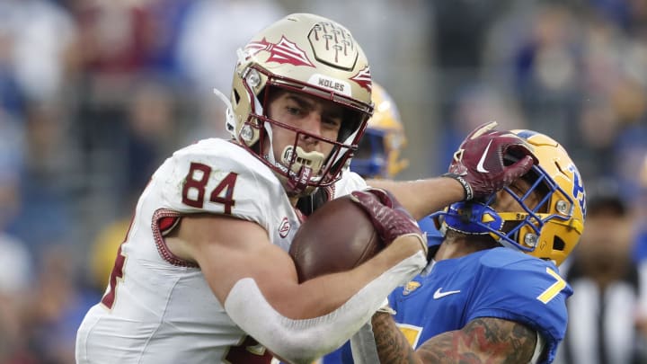 Nov 4, 2023; Pittsburgh, Pennsylvania, USA;  Florida State Seminoles tight end Kyle Morlock (84) stiff arms Pittsburgh Panthers defensive back Javon McIntyre (7) after a catch during the second quarter at Acrisure Stadium. Mandatory Credit: Charles LeClaire-USA TODAY Sports