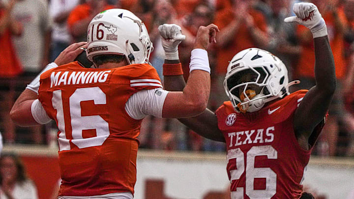 Texas Longhorns quarterback Arch Manning (16) and running back Quintrevion Wisner (26)