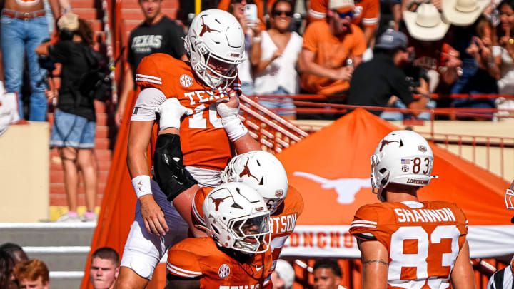 Texas Longhorns offensive lineman Conner Robertson (62) lifts quarterback Arch Manning (16) to celebrate a rushing toughdown during the game against Colorado State at Darrell K Royal-Texas Memorial Stadium in Austin Saturday, Aug. 31, 2024.