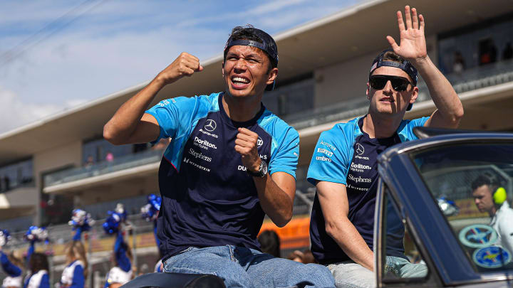 Williams Racing drivers Alexander Albon, left, and Logan Sargeant, right wave to the crowd during the drivers parade ahead of the Formula 1 Lenovo United States Grand Prix at Circuit of Americas on Sunday, Oct. 22, 2023.