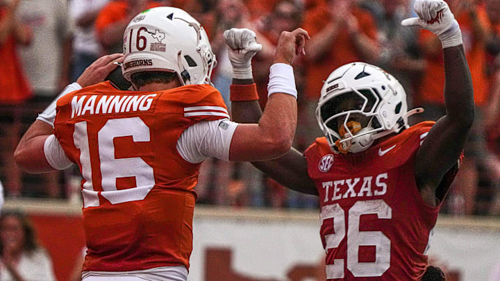 Texas Longhorns quarterback Arch Manning (16) and running back Quintrevion Wisner (26) 