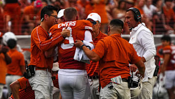 Texas Longhorns quarterback Quinn Ewers (3) is helped off the field after an injury during the game against UTSA at Darrell K Royal-Texas Memorial Stadium in Austin on Saturday, Sept. 14, 2024.