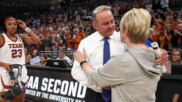 Texas Longhorns head coach Vic Schaefer meets Alabama head coach Kristy Curry after the 65-54 win