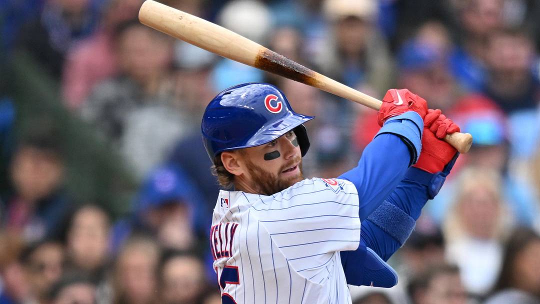 May 3, 2026; Chicago, Illinois, USA; Chicago Cubs catcher Carson Kelly (15) hits an RBI single against the Arizona Diamondbacks during the second inning at Wrigley Field. 