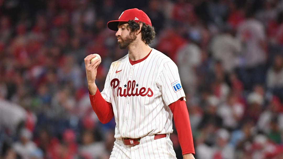 May 27, 2025; Philadelphia, Pennsylvania, USA; Philadelphia Phillies pitcher Jordan Romano (68) checks the baseball before the start of the ninth inning against the Atlanta Braves at Citizens Bank Park. 