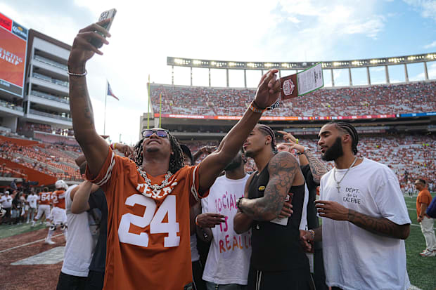 The San Antonio Spurs take a selfie on the field during the Texas Longhorns match against the UTSA in Darrell K Royal - Texas Memori