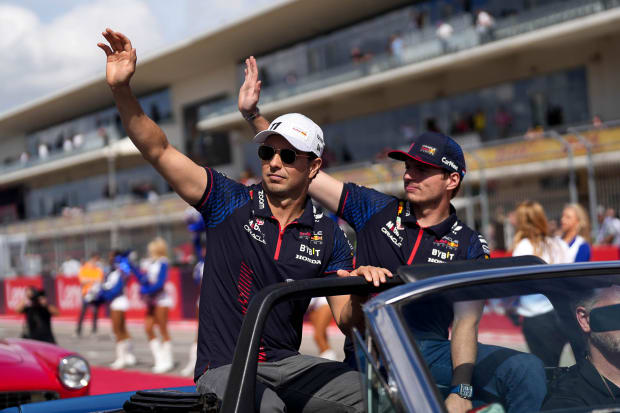 Oracle Red Bull Racing drivers Sergio Perez, left, and Max Verstappen, right, wave to the crowd