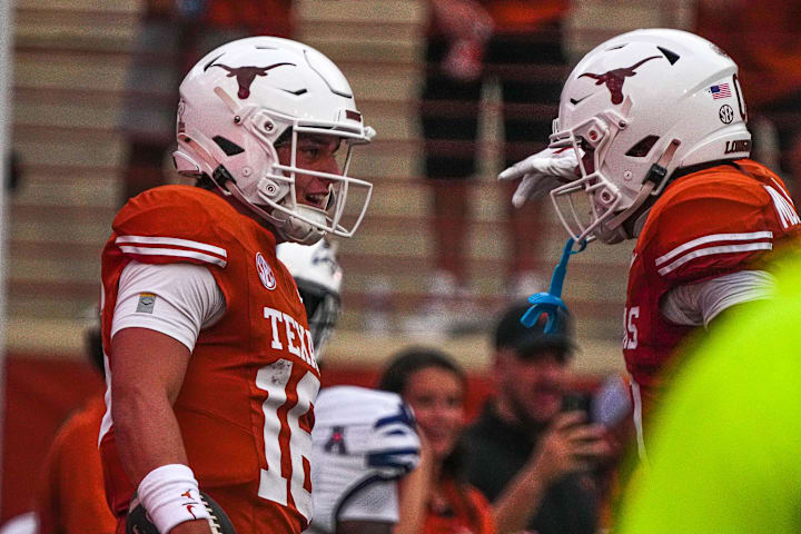 Texas Longhorns quarterback Arch Manning and receiver DeAndre Moore Jr. celebrate a touchdown against UTSA 