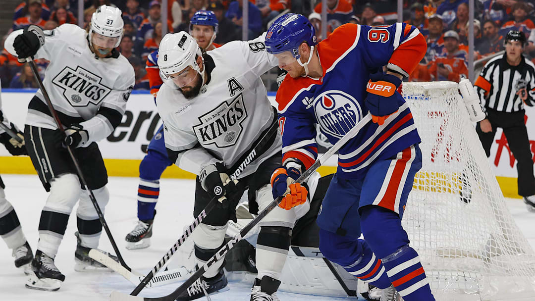 May 1, 2025; Edmonton, Alberta, CAN; Edmonton Oilers forward Corey Perry (90) battles with Los Angeles Kings defensemen Drew Doughty (8) for a loose puck during the first period in game six of the first round of the 2025 Stanley Cup Playoffs at Rogers Place. Mandatory Credit: Perry Nelson-Imagn Images