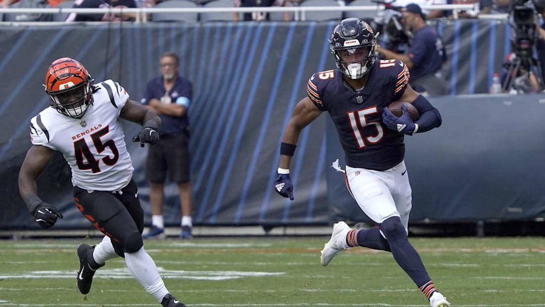 Aug 17, 2024; Chicago, Illinois, USA; Chicago Bears wide receiver Rome Odunze (15) catches a pass as Cincinnati Bengals linebacker Maema Njongmeta (45) pursues him during the first half at Soldier Field. Mandatory Credit: David Banks-Imagn Images