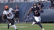 Aug 17, 2024; Chicago, Illinois, USA; Chicago Bears wide receiver Rome Odunze (15) catches a pass as Cincinnati Bengals linebacker Maema Njongmeta (45) pursues him during the first half at Soldier Field. Mandatory Credit: David Banks-Imagn Images