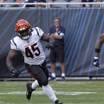 Rome Odunze catches a pass as Bengals linebacker Maema Njongmeta gives pursuit in preseason.