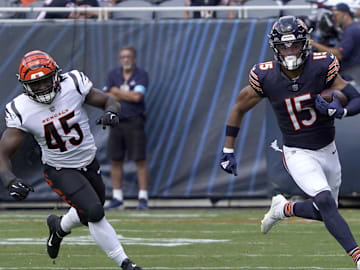 Aug 17, 2024; Chicago, Illinois, USA; Chicago Bears wide receiver Rome Odunze (15) catches a pass as Cincinnati Bengals linebacker Maema Njongmeta (45) pursues him during the first half at Soldier Field. Mandatory Credit: David Banks-Imagn Images